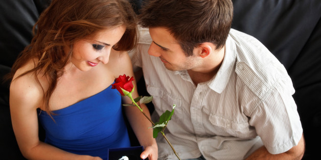 Young man's gifts for Valentine's day to his girfriend - a single rose and a crystal heart - late teenager heterosexual couple