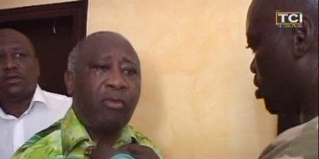 In this image made from television, Laurent Gbagbo, centre, puts on a shirt after his arrest, at the Golf Hotel in Abidjan, Ivory Coast, Monday, April 11, 2011. After a week of heavy fighting, forces backing Ivory Coast's internationally recognized leader Alassane Ouattara on Monday arrested strongman Laurent Gbagbo who had refused to leave the presidency despite losing elections more than four months earlier. (AP Photo/TCI via APTN)