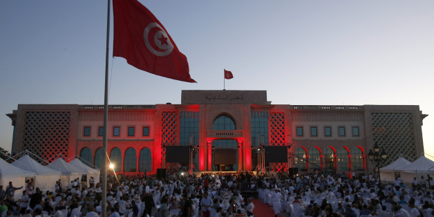 People break the fast at the main square in the capital Tunis, Tunisia, Thursday, July 2, 2015. Government minister Kamel Jendoubi told reporters Thursday that eight people who are still being detained â seven men and one woman â are suspected of direct links to an attack which took place last week in Sousse. (AP Photo/Darko Vojinovic)
