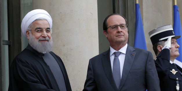 French president Francois Hollande, right, welcomes Iranian President Hassan Rouhani before a meeting at the Elysee Palace, in Paris, Thursday, Jan. 28, 2016. France has welcomed Iranian President Hassan Rouhani with a lucrative car-making agreement and pledges to boost trade after a diplomatic deal easing nuclear tensions. (AP Photo/Christophe Ena)