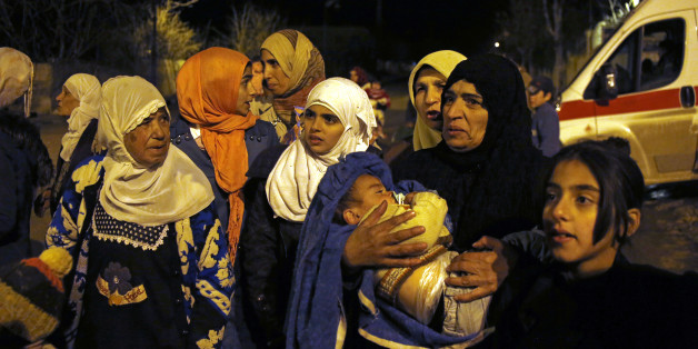 In this Monday, Jan. 11, 2016 photo, people wait to leave the besieged town of Madaya, northwest of Damascus, Syria. Aid convoys reached three besieged villages on Monday â Madaya, near Damascus, where U.N. humanitarian chief Stephen O'Brien said about 400 people need to be evacuated immediately to receive life-saving treatment for medical conditions, malnourishment and starvation, and the Shiite villages of Foua and Kfarya in northern Syria. Reports of starvation and images of emaciated ch