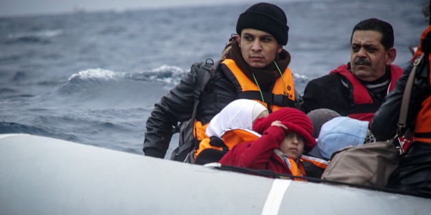Refugees and migrants on a dinghy arrive from the Turkish coast to the northeastern Greek island of Lesbos, on Friday, Jan. 29, 2016. A migration monitoring agency says deaths of refugees and migrants crossing the Aegean Sea between Turkey and Greece are "increasing at an alarming rate" as 218 people have died in January on that eastern Mediterranean route. (AP Photo/Mstyslav Chernov)