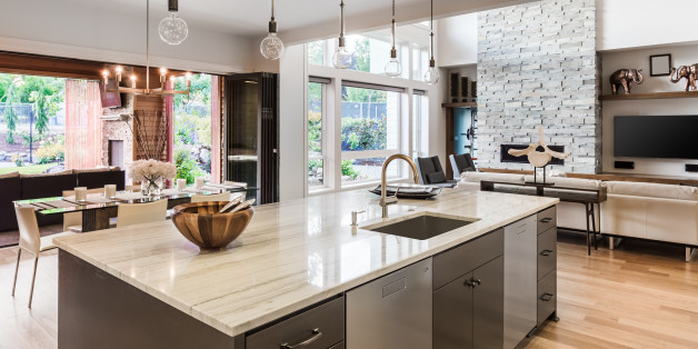 Kitchen with Island, Sink, Cabinets, and Hardwood Floors in New Luxury Home, with View of Living Room, Dining Room, and Outdoor Patio