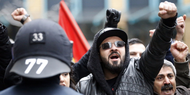 Police forces guard Salafists during a demonstration of Patriotic Europeans against the Islamization of the West, or PEGIDA, and Salafists in Wuppertal, Germany, Saturday, March 14, 2015. (AP Photo/Frank Augstein)