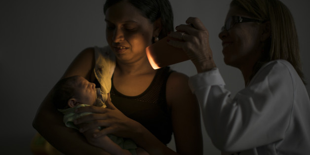 Daniele Ferreira dos Santos holds her son Juan Pedro as he undergoes visual exams at the Altino Ventura foundation in Recife, Pernambuco state, Brazil, Thursday, Jan. 28, 2016. Santos is at the epicenter of the Zika outbreak, and Pedroâs is among 3,400 suspected cases of microcephaly that may be connected to the virus, though no link has yet been proven. (AP Photo/Felipe Dana)