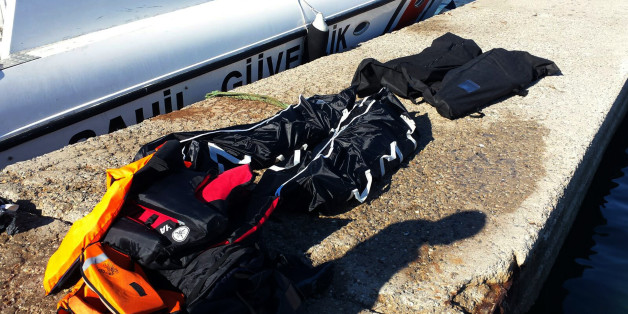 Dead bodies of migrants lie on the ground in Seferihisar port near Izmir, Turkey, Tuesday, Feb. 2, 2016. A Turkish news agency says that a number of migrants including children have drowned in a new boat sinking accident off the Turkish coast. The private Dogan news agency says the migrants drowned Tuesday near the Aegean coastal town of Seferihisar, which is close to the Greek island of Samos. (AP Photo)