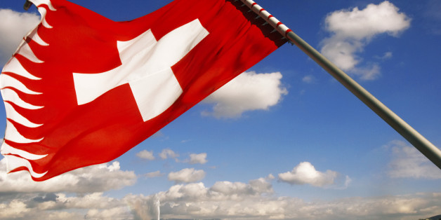 Switzerland, Geneva, Lake Geneva, Swiss flag in foreground