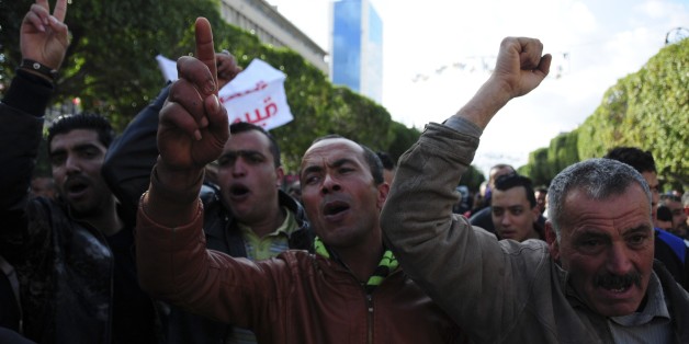 Unemployed tunisian people stage a protest in a precarious calm enforced by a nationwide curfew in Habib Bourguiba avenue, center downtown of Tunis, Saturday Jan. 23, 2016. Tunisia's president vowed Friday to end the cycle of unrest that has pummeled towns across the country as authorities imposed a nationwide curfew, five years after the nation, convulsed by protests, overthrew its longtime ruler and moved onto the road to democracy. (AP Photo/Riadh Dridi)