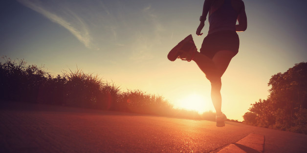 Runner athlete running at seaside road. woman fitness silhouette sunrise jogging workout wellness concept.vintage effect