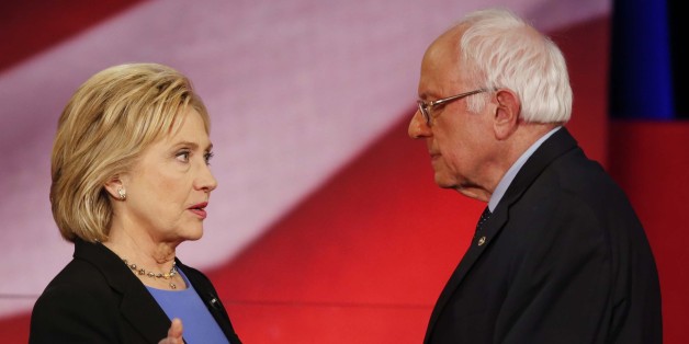 Democratic presidential candidate, Hillary Clinton and Democratic presidential candidate, Sen. Bernie Sanders, I-Vt. speak during a break at the NBC, YouTube Democratic presidential debate at the Gaillard Center, Sunday, Jan. 17, 2016, in Charleston, S.C. (AP Photo/Mic Smith)