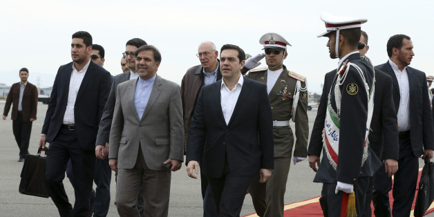 Greek Prime Minister, Alexis Tsipras, center, is welcomed by Iranian Transport Minister Abbas Akhoundi, center left, as he arrives at Mehrabad Airport, Tehran, Iran, Sunday, Feb. 7, 2016. (AP Photo/Vahid Salemi)