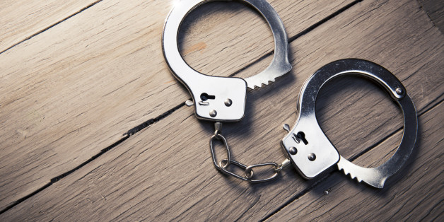 Closed handcuffs, Security concept on wooden background