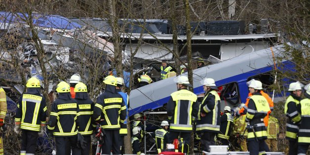 Rescue personnel stand in front of two trains that collided head-on near Bad Aibling, southern Germany, Tuesday, Feb. 9, 2016. Several people have been killed and dozens were injured. (AP Photo/Matthias Schrader)