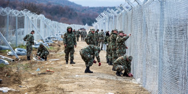 Macedonian soldiers build a second border fence to prevent illegal crossings by migrants at the Greek-Macedonian border near Gevgelija on February 8, 2016.
Macedonia started on February 8, 2016 erecting double razor fence,digging holes, erecting pillars, erecting razor fence and is extending fence on new places along side by Greek border line. / AFP / Robert ATANASOVSKI (Photo credit should read ROBERT ATANASOVSKI/AFP/Getty Images)