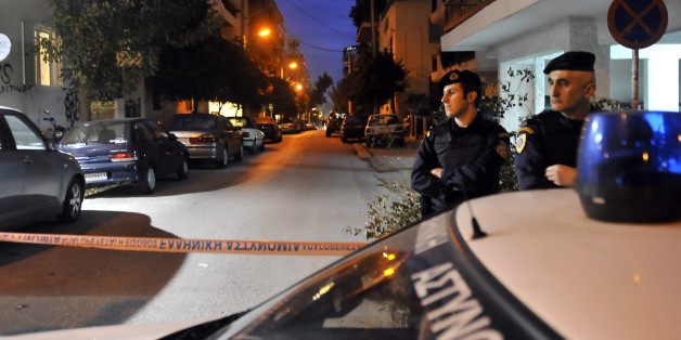 Greek police investigate after anti-terrorist police arrested four men and detained several other suspects after discovering a large weapons cache on December 4, 2010 in an Athens suburb. The arrests, which include a suspected bank robber, were carried out following a police raid on a garage in the district of Nea Smyrni, a few kilometres (miles) from Athens, and in other homes in the capital. AFP PHOTO/STR (Photo credit should read STR/AFP/Getty Images)