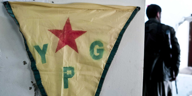 FILE - In this Nov. 2, 2014 photo, pictures adorn the wall of a position held by Kurdish popular protection (YPG) and women's defense (YPJ) units of fighters who have been lost in the battles against the Islamic State group in Kobani, Syria. The Syrian Kurds fighters earned praise from the Pentagon. But unlike Syrian rebels, they are not included in a new U.S.-training program. And unlike their Kurdish brethren in Iraq, they have not been tapped to receive American weapons. (AP Photo/Jake Simkin, File)