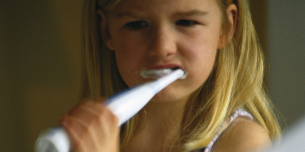 Little girl with electric toothbrush.