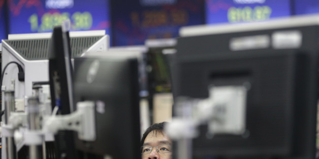 A currency trader watches monitors at the foreign exchange dealing room of the KEB Hana Bank headquarters in Seoul, South Korea, Friday, Feb. 12, 2016. Japanâs main stock index dived Friday, leading other Asian markets lower, after a sell-off in banking shares roiled investors in the U.S. and Europe. (AP Photo/Ahn Young-joon)