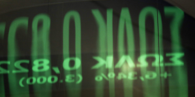 A reflection of share prices on an electronic ticker screen sits on a glass door panel inside the Athens Stock Exchange on Wednesday, Aug. 5, 2015. Greece's government aims to reach agreement with creditors on a new bailout within the next two weeks, enabling it to make a 3.2 billion-euro ($3.5 billion) payment to the European Central Bank without further bridge financing. Photographer: Kostas Tsironis/Bloomberg via Getty Images