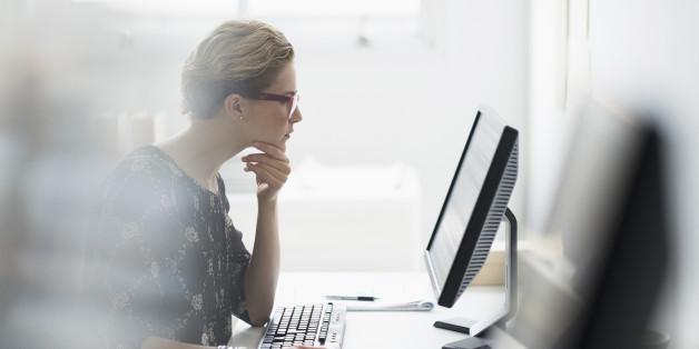 USA, New Jersey, Side view of business woman working on desktop pc in office