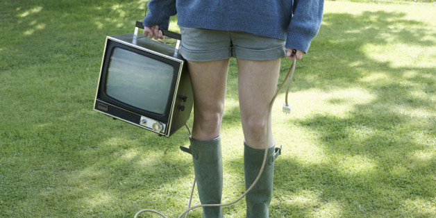 Portrait of girl holding retro TV