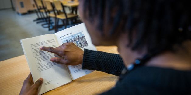 Ein jugendlicher Flüchtling aus Liberia liest in einer Berufsbildenden Schule in Hannover in einem Lehrbuch zur Sprachförderung (Archivbild)