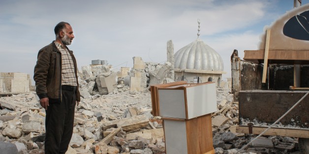 In this Saturday, Nov. 17, 2012 photo, a Syrian man salvages furniture from his home that was destroyed in bombing by government forces, in the northwestern city of Maraat al-Numan, Syria. After months of fierce fighting for control of the vital Aleppo-Damascus highway, rebels have succeeded in pushing the Syrian army out of the center of Maraat al-Numan located on the highway between Aleppo and Hama. (AP Photo/Mustafa Karali)