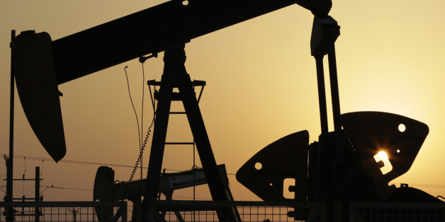 oil pumps work in the desert oil fields of Sakhir, Bahrain.