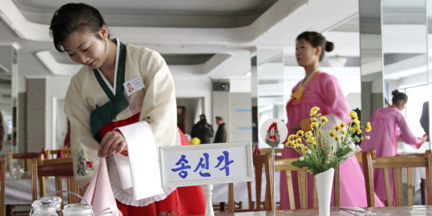 A North Korean waitress folds a napkin before the start of a cooking competition held at a noodle restaurant in Pyongyang, North Korea, on Thursday, Nov. 22, 2012. Cooks and servers from around North Korea took part in the three-day cooking competition. (AP Photo/Jon Chol Jin)