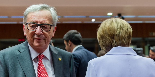 European Commission President Jean-Claude Juncker, left, walks by German Chancellor Angela Merkel during a round table meeting at an EU summit in Brussels on Thursday, June 25, 2015. Greece and its creditors launched a new round of talks in Brussels early Thursday in a fresh bid to unlock billions of euros in loans and save the country from bankruptcy. (AP Photo/Geert Vanden Wijngaert)
