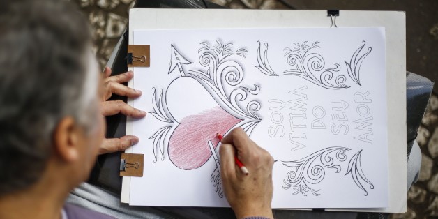 TO GO WITH AFP STORY BY NATALIA RAMOS A man colours a drawing on a street of Sao Paulo, Brazil, on June 23, 2015. Considered as 'anti-stress' passtimes, one million copies of coloring books have been already sold in Brazil and even got a new category: sex to colour. AFP PHOTO / Miguel SCHINCARIOL (Photo credit should read Miguel Schincariol/AFP/Getty Images)