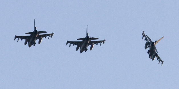 Three Dutch F-16 aircraft prepare for landing at the Decimomannu airbase, in Sardinia, Italy, Thursday, March 24, 2011. French fighter jets struck an air base deep inside Libya and destroyed one of Gadhafi's planes Thursday, and other coalition bombers struck artillery, arms depots and parked helicopters. (AP Photo/Rosi Coroneo)