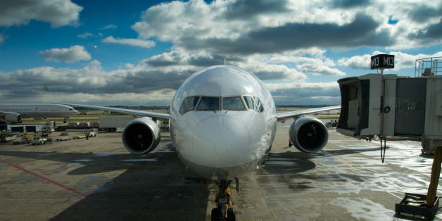 A passenger jet arriving at the gate at an international airport.