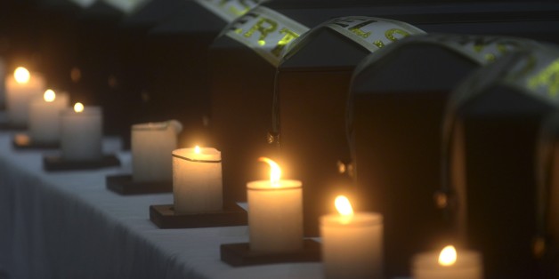 Funerary urns containing remains of people disappeared during the Colombian civil war, are seen, during a ceremony in the framework of the country's peace process in Medellin, Antioquia department, Colombia on August 29, 2014. Relatives of 19 victims received the remains of their loved ones, who were recently found in a mass grave, thanks to information provided by demobilized from both sides, the leftist guerrillas and the right-wing paramilitaries groups. AFP PHOTO/Raul ARBOLEDA (Photo credit should read RAUL ARBOLEDA/AFP/Getty Images)