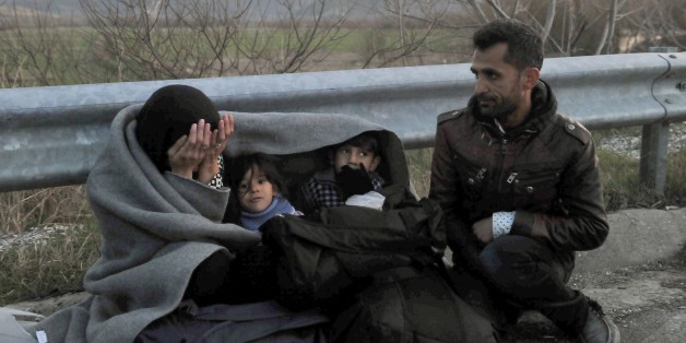 Migrants and refugees wait to cross the Greek-Macedonian border near the village of Idomeni on February 21, 2016. The police chiefs of five countries on the migrant route through southeast Europe announced an agreement on February 18 for a joint refugee registration point at the Greek-Macedonian border. Macedonia, Serbia, Croatia, Slovenia and Austria will jointly profile and register migrants from war-torn countries and then organise their 'controlled transport' through to Austria, Croatia's po
