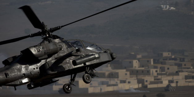 A US AH-64 Apache flies over the combat zone during a NATO military demonstration in Zaragoza, Spain, Wednesday Nov. 4, 2015. NATO is putting on its most fearsome display of military might in over a decade with soldiers, ships and planes meant to hone and test its abilities as well as send an unequivocal sign to Russia and other real or potential foes. For three weeks which started Oct. 21, more than 36,000 personnel from all 28 NATO allies and eight partner nations, 160 aircraft and 60 ships will be taking part in exercises across a wide swath of southern Europe from Portugal to Italy. (AP Photo/Abraham Caro Marin)