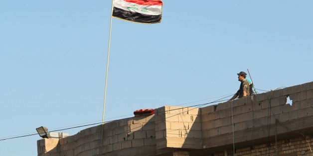 A member of Iraqi security forces stands on a roof on February 12, 2016, after security forces retook the eastern outskirts of Ramadi city from Islamic State (IS) group jihadists.
Government forces recaptured areas on the eastern outskirts of the Anbar provincial capital from IS after weeks of fighting, and authorities say that all areas immediately surrounding the city have been retaken. / AFP / AHMAD AL-RUBAYE (Photo credit should read AHMAD AL-RUBAYE/AFP/Getty Images)