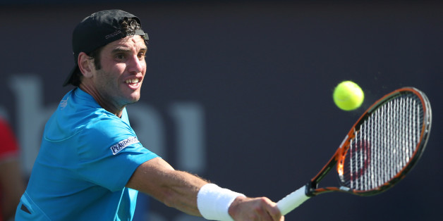 Malek Jaziri from Tunisia returns the ball to Mikhail Youzhny from Russia during a first day match of the Dubai Tennis Championships in Dubai, United Arab Emirates, Monday, Feb. 22, 2016. (AP Photo/Kamran Jebreili)