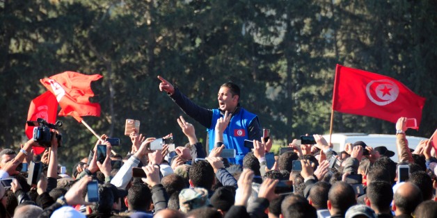 Hundred of police officers shouts slogans as they demonstrate outside the presidential palace in Carthage near Tunis, Tunisia, to demand a pay increase, Monday, Jan. 25, 2016. Tunisian Prime Minister Habib Essid has pleaded for "patience" following a wave of violent demonstrations against poverty and unemployment, the worst social unrest since the 2011 revolution. (AP Photo/Riadh Dridi)
