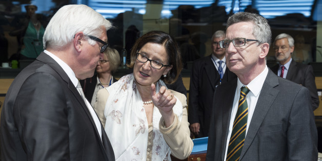 German Foreign Minister Frank-Walter Steinmeier, left, speaks with Austrian Justice Minister Johanna Mikl-Leitner, center, and German Justice Minister Thomas de Maiziere during a meeting of EU foreign ministers at the EU Council building in Luxembourg on Monday, April 20, 2015. An Italian coast guard ship headed toward Sicily Monday to look for survivors of a capsized ship in what could be the Mediterranean's deadliest migrant tragedy, as EU foreign ministers gathered for an emergency meeting to discuss the crisis. (AP Photo/Thierry Monasse)