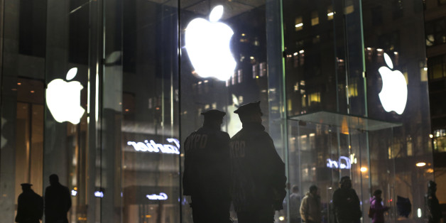New York police officers stand outside the Apple Store on Fifth Avenue while monitoring a demonstration, Tuesday, Feb. 23, 2016, in New York. Protesters assembled in more than 30 cities around the world to lash out at the FBI for obtaining a court order that requires Apple to make it easier to unlock an encrypted iPhone used by a gunman in December's mass murders in California. (AP Photo/Julie Jacobson)