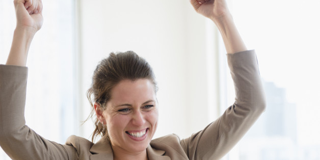 Portrait of cheering woman in office