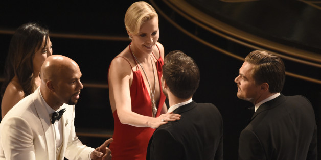 Common, from left, Charlize Theron, Tobey Maguire, and Leonardo DiCaprio are seen in the audience at the Oscars on Sunday, Feb. 28, 2016, at the Dolby Theatre in Los Angeles. (Photo by Chris Pizzello/Invision/AP)