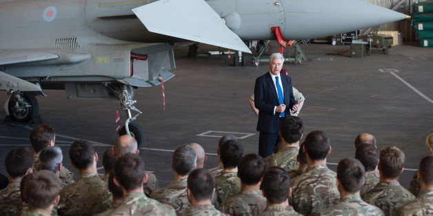 British Defence minister Michael Fallon talks to British pilots and soldiers at RAF Akrotiri, a British air base near the coastal city of Limassol, Cyprus, Saturday, Dec. 5, 2015. British warplanes carried out airstrikes in Syria early Thursday, hours after Parliament voted to authorize air attacks against Islamic State group targets there. Eight more British jets arrived at RAF Akrotiri to join the attacks. (AP Photo/Pavlos Vrionides)