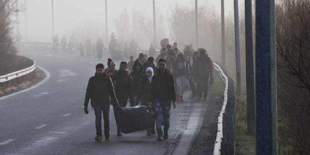 Syrian refugees walk through a motorway towards the Greek border station of Idomeni Tuesday, March, 1 2016. Some 7,000 migrants, including many from Syria and Iraq, are crammed into a tiny camp at the Greek border village of Idomeni, and hundreds more are arriving daily. (AP Photo/Petros Giannakouris)