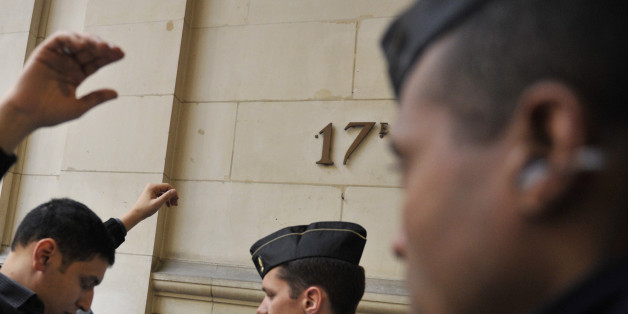 A man is searched before entering the courtroom where a man stands trial accused of operating an al-Qaida propaganda website on charges of promoting terrorism, Tuesday, March 4, 2014, in Paris. 27-year old Romain Letellier faces up to five-years in prison if convicted under a new law against âcyberjihadâ, even though no attacks are proved to be linked to the site. (AP Photo/Zacharie Scheurer)