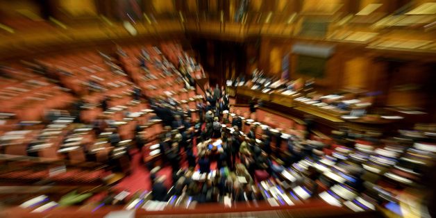 Italian senators attend a debate on the same-sex couples civil union, prior to the final vote, at the Italian Senate in Rome, on February 25, 2016.
Prime Minister Matteo Renzi is bowing to Catholic pressure to remove stepchild adoption rights from the civil unions bill to ease its passage through parliament -- to the fury of gay rights groups. Renzi has called for a vote of confidence on the draft law and without the stepchild clause. A maxi-amendment to a Democratic Party (PD) civil unions bill passed in a vote of confidence in the Senate approved with 173 in favor, 71 against and none abstaining. / AFP / FILIPPO MONTEFORTE (Photo credit should read FILIPPO MONTEFORTE/AFP/Getty Images)