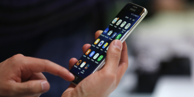 A man holds the Samsung Galaxy S7 Edge during the Samsung Galaxy Unpacked 2016 event on the eve of this weekâs Mobile World Congress wireless show, in Barcelona, Spain, Sunday, Feb. 21, 2016. (AP Photo/Manu Fernadez)