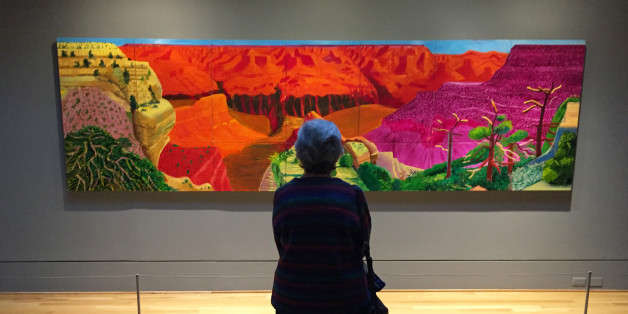 This Feb. 20, 2016 photo shows a visitor gazing at David Hockney's depiction of the Grand Canyon in a show called "Seeing Nature" at the Phillips Collection in Washington, D.C. The Phillips, a modern art museum, is one of the top attractions in the Dupont Circle neighborhood. (AP Photo/Beth J. Harpaz)