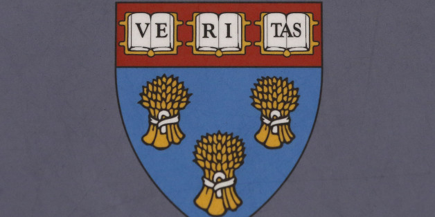 FILE - In this Tuesday, Nov. 10, 2015, file photo, the Harvard Law School seal is shown attached to a sign on the Harvard University campus in Cambridge, Mass. A committee of faculty, students, alumni and staff recommended Friday, March 4, 2016, that Harvard Law School drop the official shield depicting three bundles of wheat. The image was borrowed from the family crest of Isaac Royall Jr., a wealthy merchant who donated his estate to create the first law professorship at Harvard University. Ro